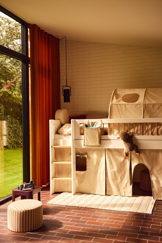 FLEXA loft bed and ROSE Back Rest Cushion in childrens room with soft toy, window, and child-safe rounded edges visible.