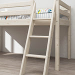 Escalera inclinada blanca FLEXA para cama alta de la colección CLASSIC, ropa de cama a rayas y suelo de madera aclarado por la luz del sol en una habitación infantil de estilo minimalista.